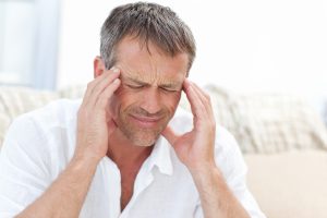 tmj symptoms - man holding temples